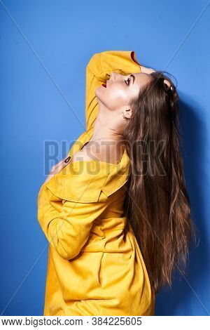 The Girl In The Yellow Coat Is Posing