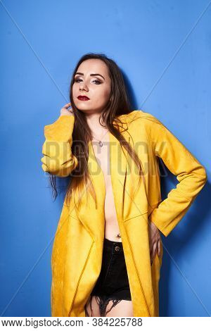 The Girl In The Yellow Coat Is Posing