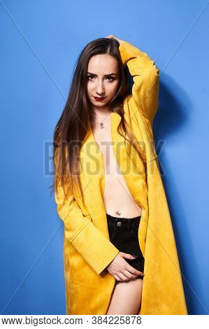 The Girl In The Yellow Coat Is Posing