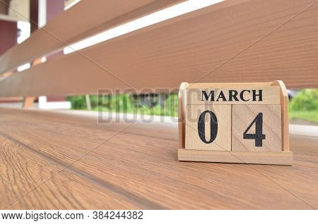 March 4, Number Cube With Wooden Balcony Background.
