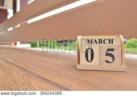 March 5, Number Cube With Wooden Balcony Background.