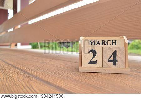 March 24, Number Cube With Wooden Balcony Background.