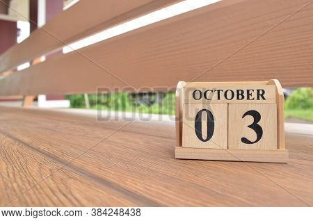 October 3, Number Cube With Wooden Balcony Background.
