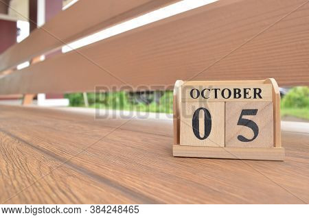 October 5, Number Cube With Wooden Balcony Background.