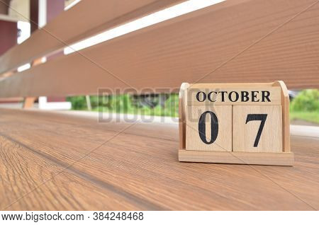 October 7, Number Cube With Wooden Balcony Background.