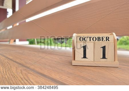 October 11, Number Cube With Wooden Balcony Background.