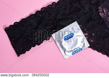 Kyiv, Ukraine - 28 June 2020: Durex  Invisible Condom Near Women's Black Panties On A Pink Backgroun