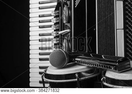 Old Accordion, Harmonica, Bong And Microphone On A Rustic Wooden Surface With Black Background And L