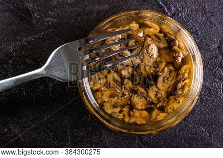 Glass Jar Of Sprots With A Fork On A Concrete Background