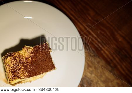 Tiramisu Slice On White Plate On Wooden Table