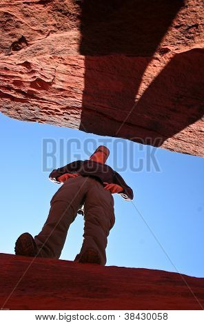 Active Senior Man Looking over Desert Canyon Crevasse