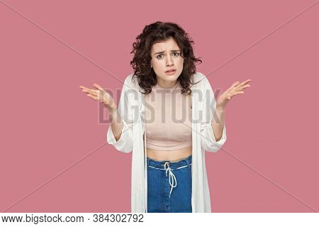 What Do You Want? Portrait Of Angry Brunette Young Woman With Curly Hairstyle In Casual Style Standi