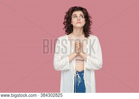 My God Please Help Me. Portrait Of Worried Hopeful Beautiful Brunette Young Woman With Curly Hairsty