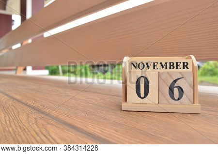 November 6, Number Cube With Wooden Balcony Background.