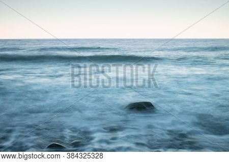 Scenic Long Exposure Close Up Of Rocky Baltic Sea Coast, Blue Evning On Ruegen Island