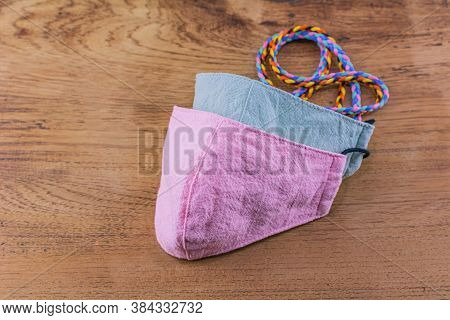 Face Mask With Neck Strap Placed On Wooden Floor.