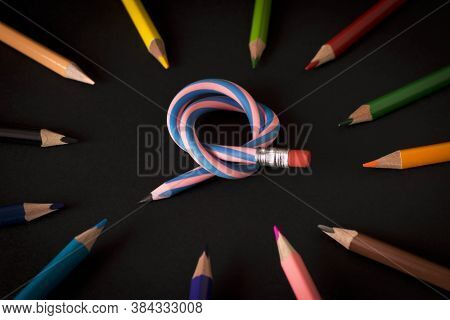 Flexible Pencil And A Set Of Colored Pencils On A Dark Background. Selective Focus