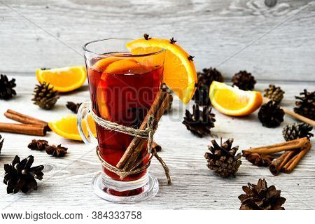 Christmas Mulled Wine With And Orange On Wooden Rustic Background. Selective Focus. Anise Stars And 