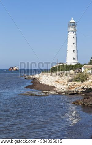 Tarkhankut Lighthouse And The Skeleton Of The Cambodian Dry Cargo Ship Ibrahim Yakim, Stranded By A 