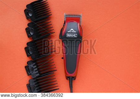 Kharkov, Ukraine - July 2, 2020 : Hairdressers Tool. Hair Clipper Wahl Close-up On A Red Background 