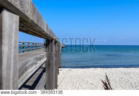 Sunny Beach Life With Some People In The Distance In Schoenberg In Northern Germany