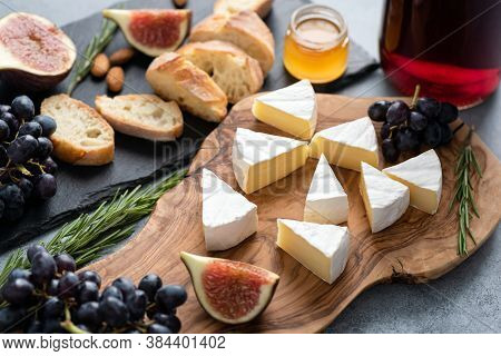 Camambert Cheese With Figs, Grapes, Honey And Wine. Gourmet Food, Appetizer Cheese Plate