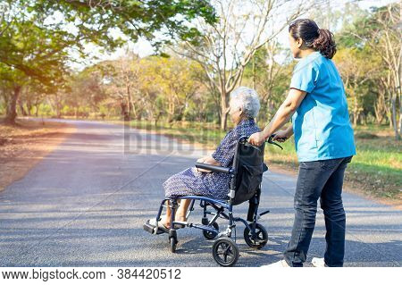 Doctor Help And Care Asian Senior Or Elderly Old Lady Woman Patient Sitting On Wheelchair At Park In