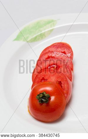 juicy red tomatoes in table cloth . caro background