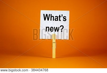 White Paper With Text 'whats New', Clip On Wood Clothespin. Beautiful Orange Background. Business Co
