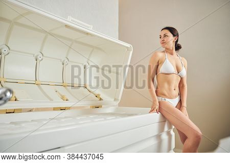 Confident Lady In Swim Suit Standing In Spa Center