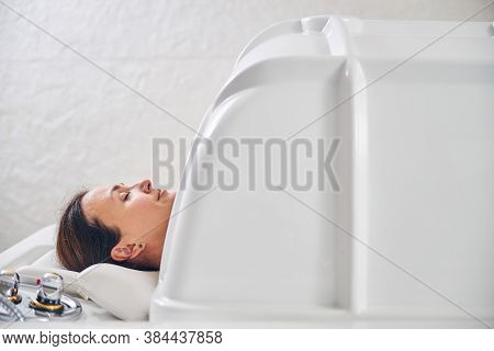 Calm Woman During The Beauty Treatment In Modern Equipment