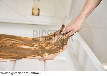 Putting Nourishing Body Mask On The Toes For Spa Treatment