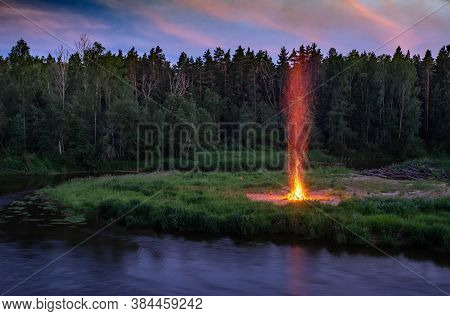 Landscape Of Pine Forest And River. Sunset Sky. Huge Fire. Midsummer Ligo Celebration. Latvian Tradi