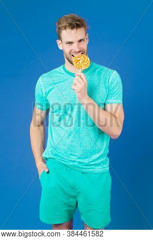 Man Bites Big Sweet Lollipop. Man With Bristle Likes Sweets. Spoiled Diet. Cheat Meal Concept. Sugar