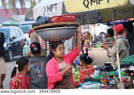 Yangon, Myanmar, Feb 24, 2019: Myanmese Woman With Thanakha (myanmar Powder) On Her Face Put Big Alu