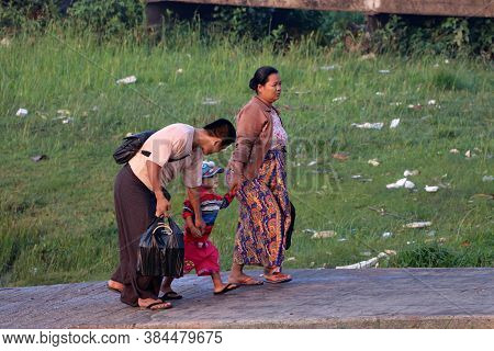 Yangon, Myanmar, Feb 25, 2019: Family Passenger Walk Together From Myanmar Traditional Ferry Across 