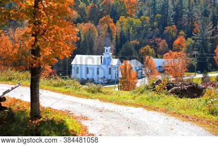 Historic church in West Barnet village in Vermont during autumn time