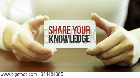 Businessman Holding A Card With Text Share Your Knowledge