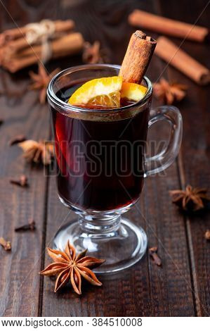 Glass Of Red Glogg Or Mulled Wine With Orange Slices And Cinnamon Stick On A Dark Wooden Background,