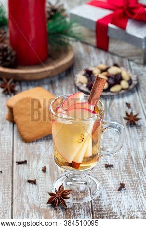 Glass Of White Glogg Or Mulled Wine With Apple Slices And Cinnamon Stick, Gingerbread Cookies And Gi