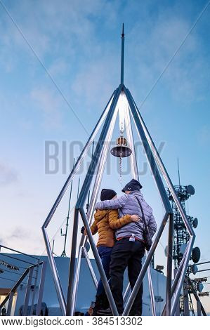 Sapporo, Hokkaido, Japan - December 2019 : A Love Couple Ringing The Bell At Top Of Mt. Moiwa In Sap