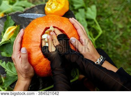 Daughter And Father Hands Carving Pumpkin For Halloween, Prepares Jack Olantern