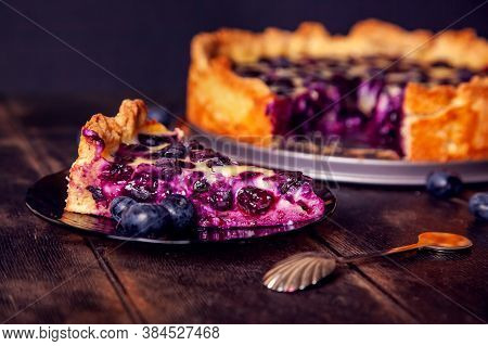 Rustic Shortbread Pie With Blueberries In Sour Cream Filling On A Wooden Background With Piece Cut O