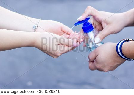Two Girls Washing Their Hands With Alcogel