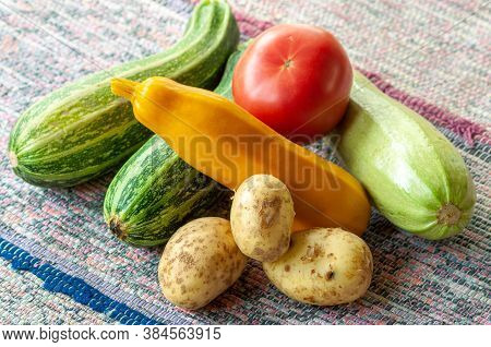 Rural Still Life With A Crop Of Vegetables On A Woven Carpet