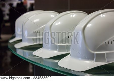 White Construction Helmets Lying On A Table In A Row