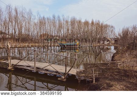 Landscape With A Pond, Bridge, Old Sailboat. Ertil Village. Voronezh Region. Russia. March 2020