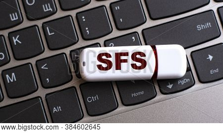 Sfs (shout Out For Shout Out) - The Word On A White Flash Drive, Lying On A Black Laptop Keyboard. I