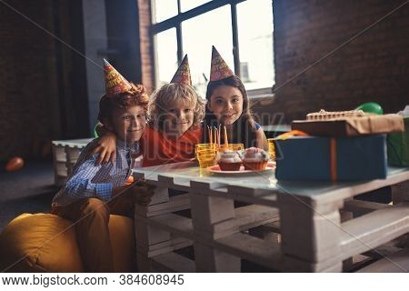 Three Kids Celebrating Bday And Feeling Joyful
