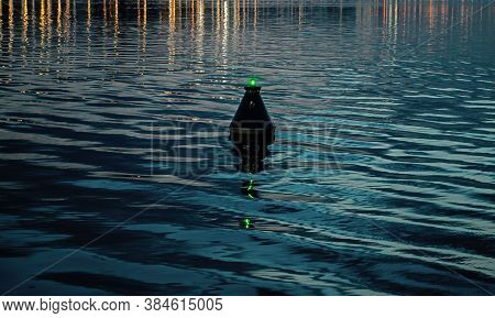 View Of The Blue Dark Waters Of The River And The Buoy, Which Sways On The Waves. Buoy Sways In Twat